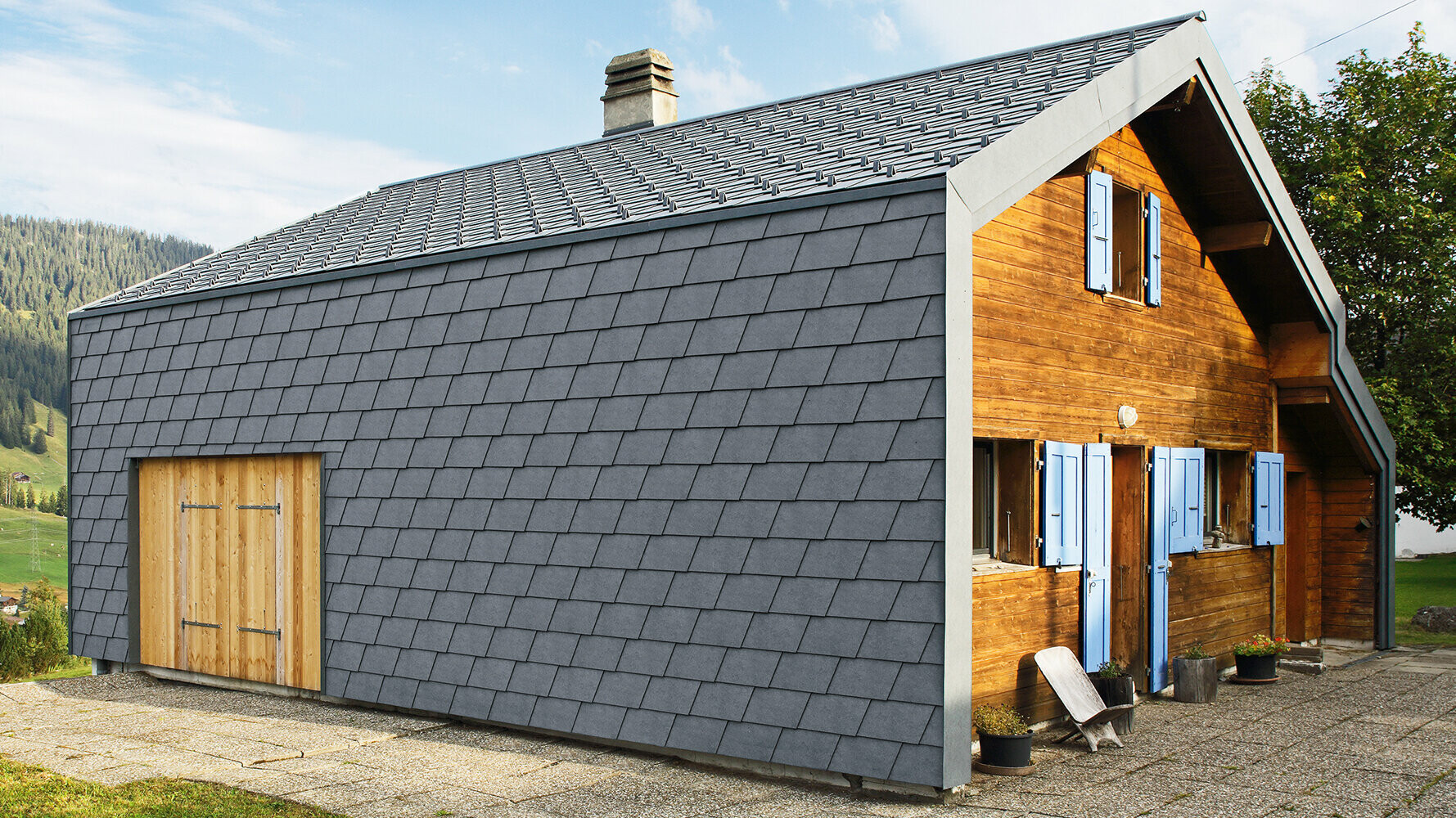 Modern detached house clad with PREFA façade shingles in anthracite and wooden elements.